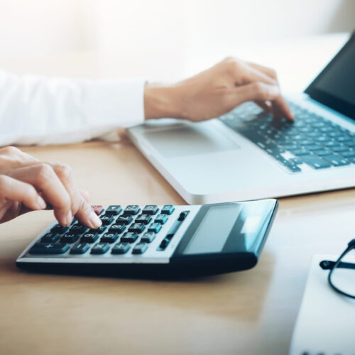 Finances Saving Economy concept. Female accountant or banker use calculator.